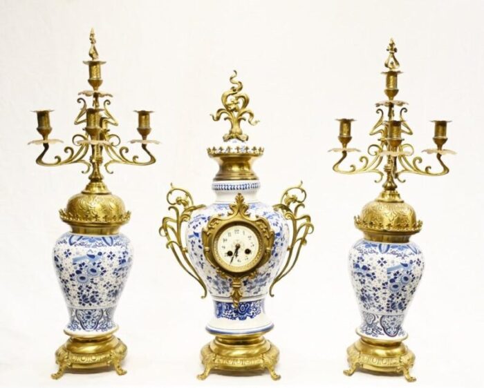 gilt delft porcelain mantle clock and urns set of 3 1