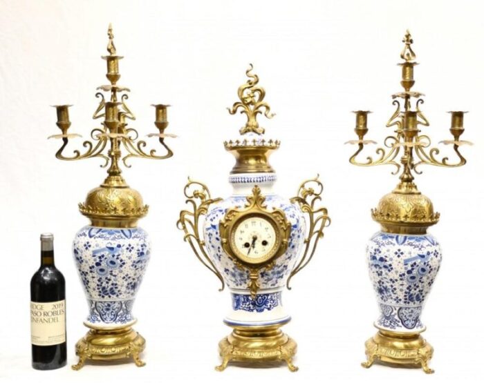 gilt delft porcelain mantle clock and urns set of 3 4