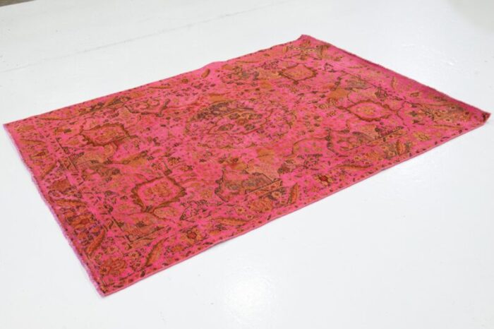 vintage overdyed persian wool rug in pink with floral motif 1855